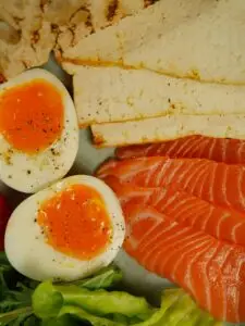 Healthy protein-rich meal with sliced salmon and boiled eggs on a plate