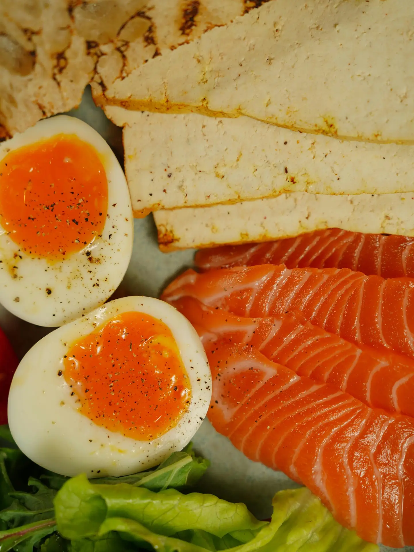 Healthy protein-rich meal with sliced salmon and boiled eggs on a plate